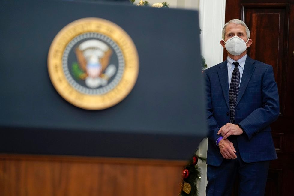 Dr. Anthony Fauci, director of the National Institute of Allergy listens as President Joe Biden...