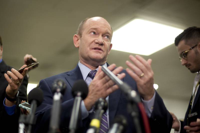 Sen. Chris Coons, D-Del., gestures while speaking to members of the media after leaving a...